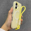 A hand holds a light yellow phone case with a lanyard attached, featuring a magnetic candy design.