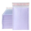 A stack of purple padded bubble mailers with self-seal closures.