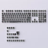 A full set of translucent PBT keycaps with side-printed legends in a cherry profile layout.