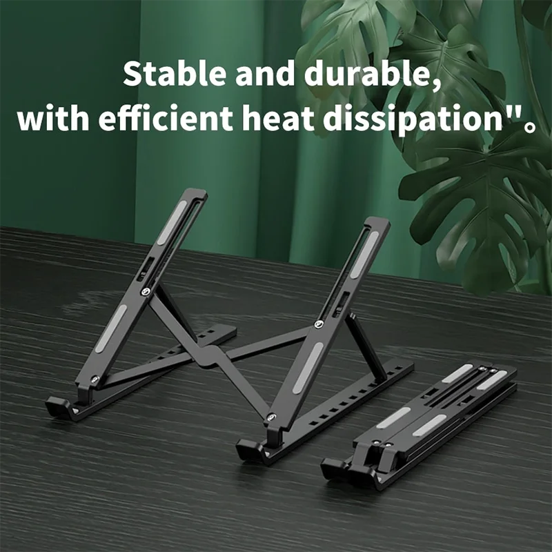 A black foldable adjustable laptop stand shown on a dark surface with a green leafy background.