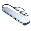 Silver multi-port USB-C hub adapter with multiple USB ports and an audio jack