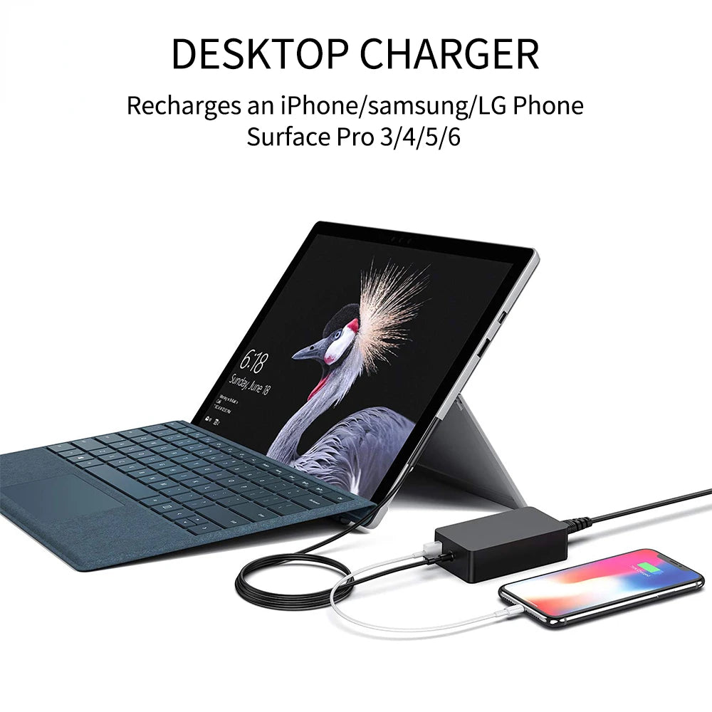 A desktop charger is shown with a cable charging an iPhone on a laptop surface.