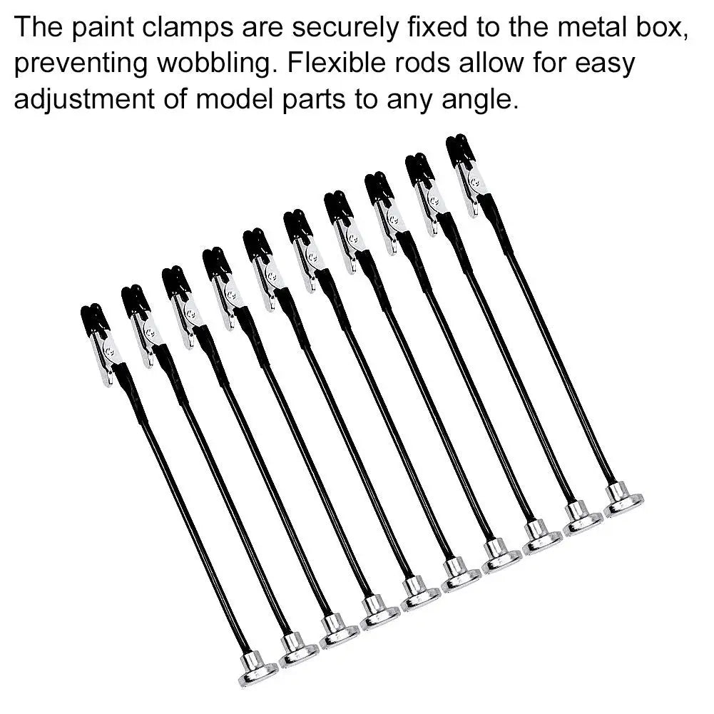 Flexible rods and clamps used to secure model parts to a metal box for adjustment.