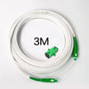 A coil of white single-mode fiber optic cable with green connectors.