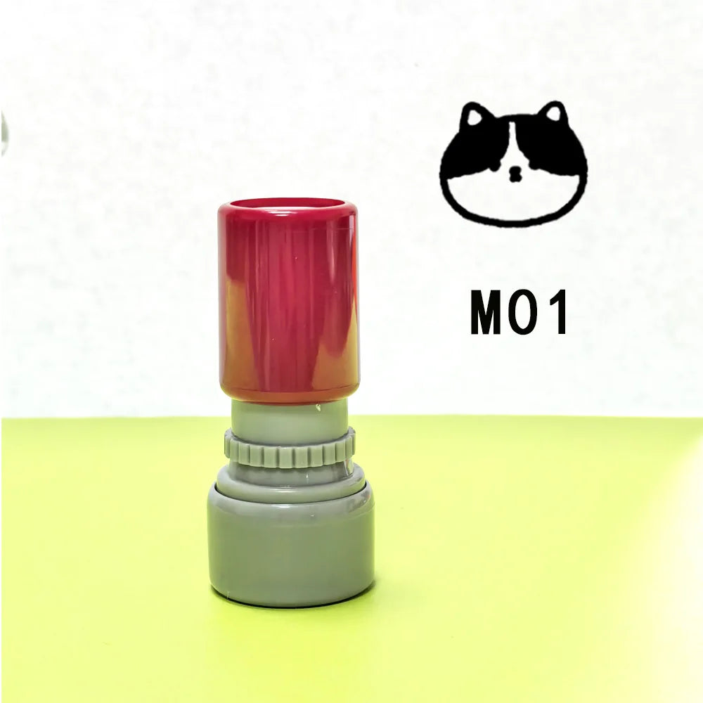 A teacher stamp with a cat face design in black and white, featuring a red top and gray base.