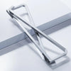 A silver foldable aluminum laptop stand with a non-slip grip shown in a diagonal angle.