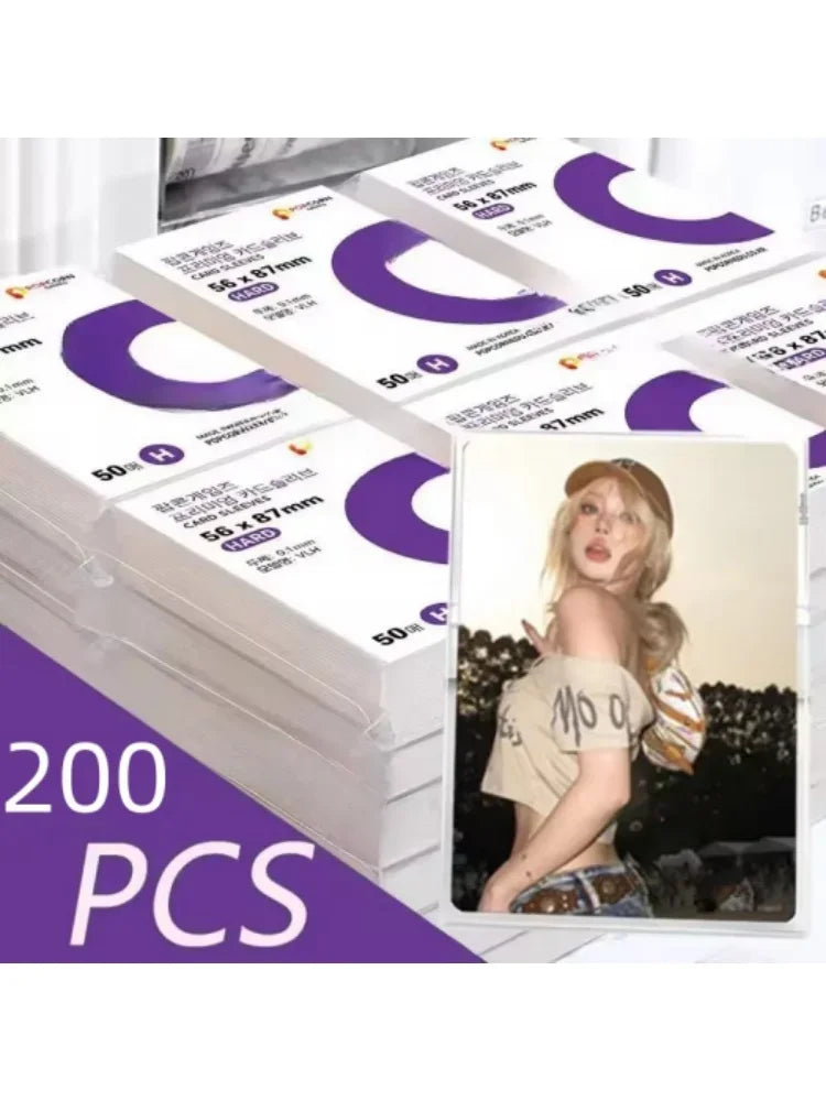 A stack of transparent protective card sleeves with purple and white designs is shown.