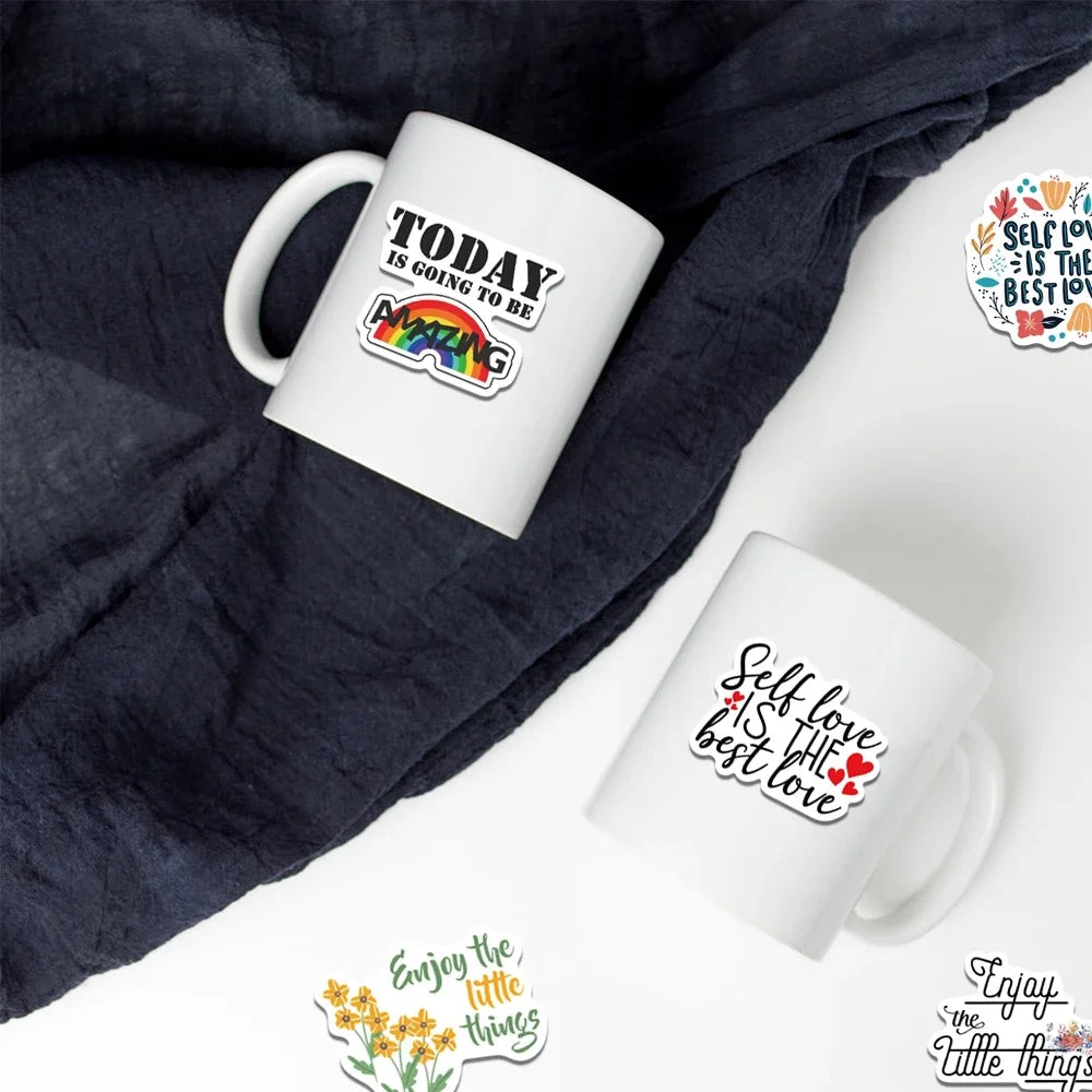 A white mug with an inspirational quote on it is placed on a dark gray fabric background.