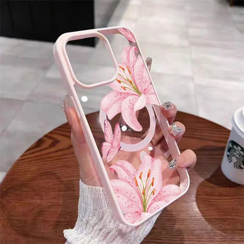 A hand holds a pink floral transparent iPhone case featuring a pink lily design.