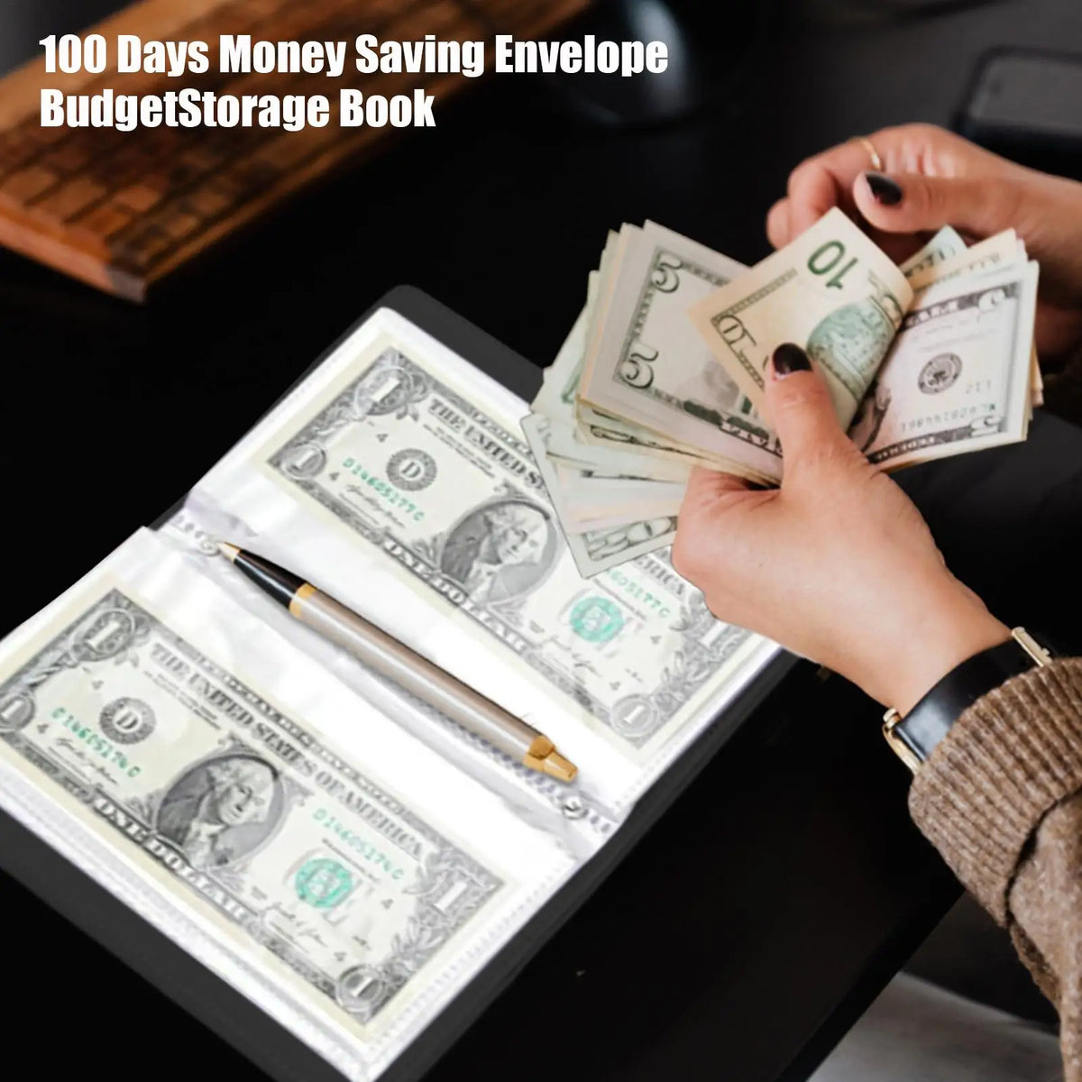 A hand is placing US dollar bills into a savings envelope within a budget storage book.