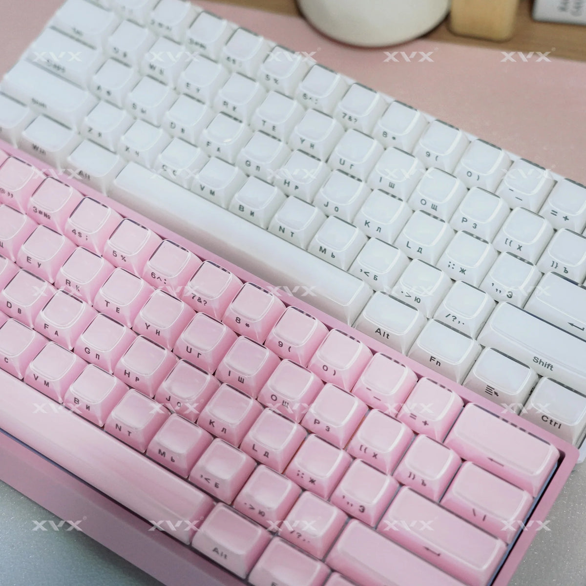 A close-up view of a pink mechanical keyboard with white keycaps and a translucent pink keycap set.