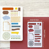 A set of reusable journal stencils featuring various patterns and shapes for scrapbooking and drawing on a white card and a r