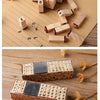 A set of vintage wooden stamp seals and alphabet blocks for card making arranged on a brown paper background.