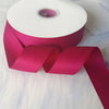Roll of matte finish satin ribbon in a deep magenta color