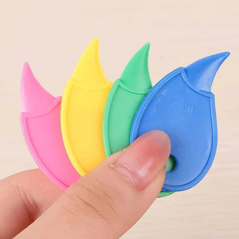 A hand holds a set of colorful mini plastic box openers and cutting tools in pink, yellow, and green.