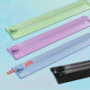 A collection of portable manual paper cutter trimmers in various shades of green, purple, and blue.
