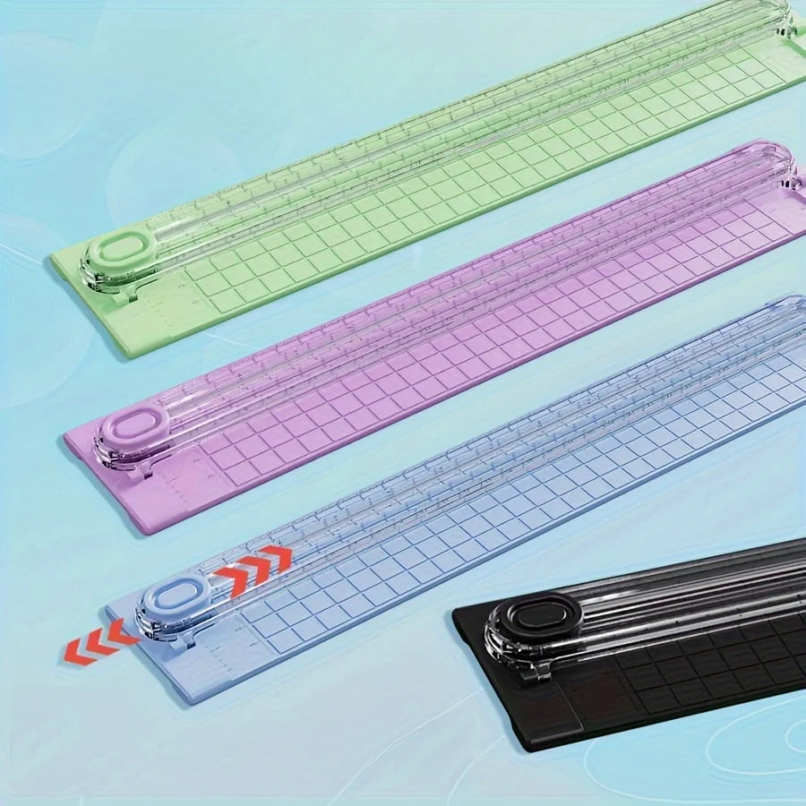 A collection of portable manual paper cutter trimmers in various shades of green, purple, and blue.