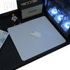 A gray professional gaming mouse pad is placed on a black desk mat next to a computer keyboard and a mouse.