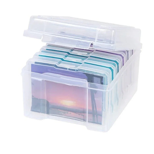 A clear plastic storage box containing several transparent photo slides or keepsakes.