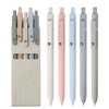 A set of six soft touch gel ink pens in various pastel shades, including pink, blue, and gray.