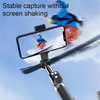 A selfie stick tripod is used to stabilize a phone camera while capturing a subject in mid-air against a blue sky.