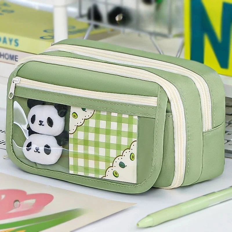 A light green pencil case with a transparent pocket featuring two panda stickers on a checkered background.