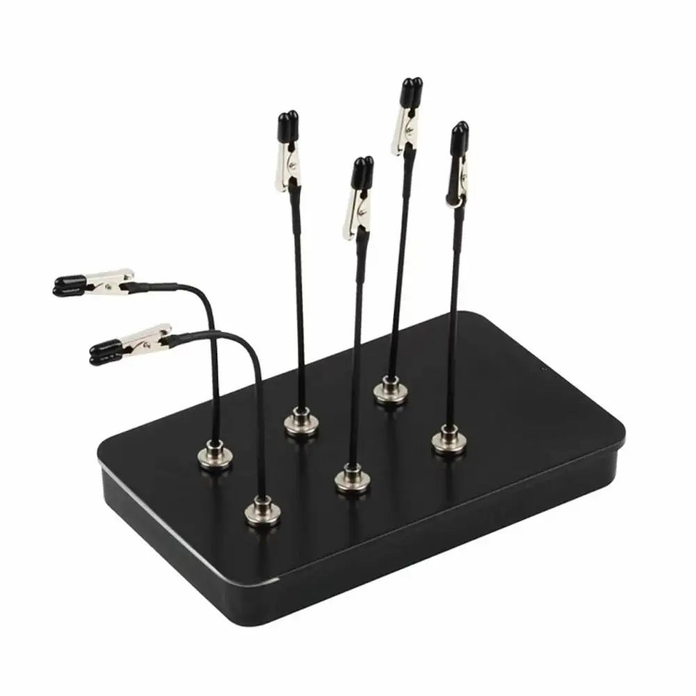 A black magnetic painting stand with four vertical holders for art and craft tools.