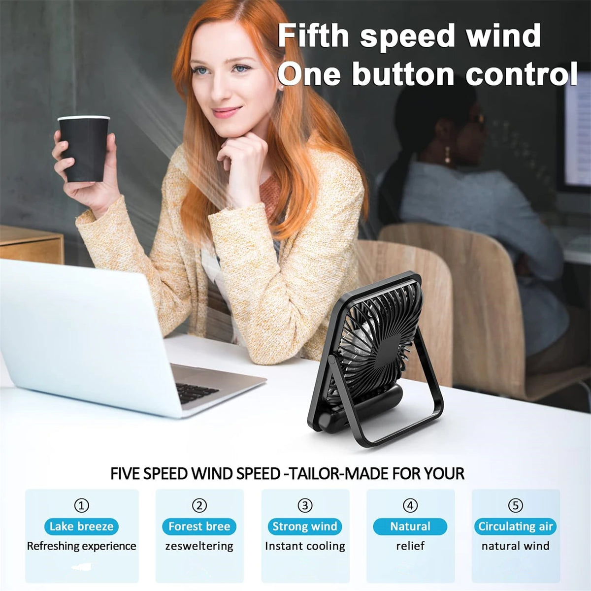 A woman is using a black portable desk fan with five speed settings on a white desk.