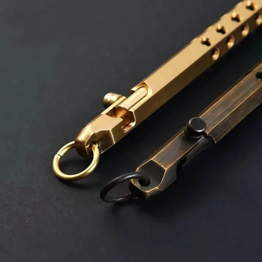 A close-up of a brass bolt-action ballpoint pen with a gold-tone finish and a dark metal clip.