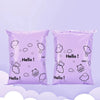 Two purple reusable plastic mailing bags filled with white cloud-shaped stickers.