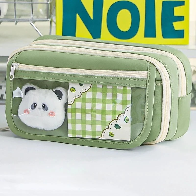 A light green pencil case with a transparent flip pocket featuring a white panda design and a checkered pattern.
