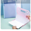 A pink accordion style storage device for A4 documents is shown open on a light green surface.