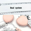 Pink PU leather measuring tape with a dual system shown next to a ruler.