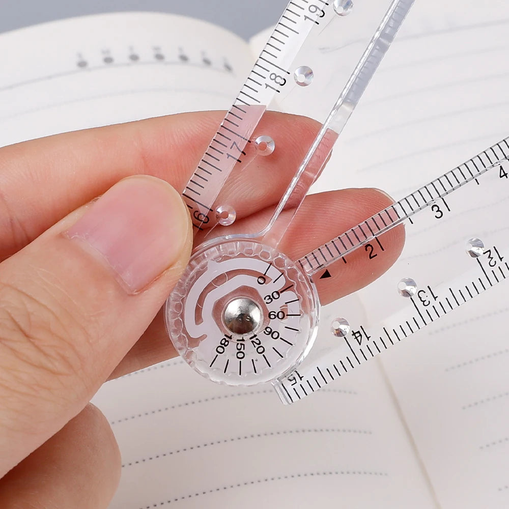 A hand holds a clear acrylic geometry ruler set with a circular protractor and a linear scale against lined paper.