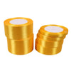 Two rolls of gold yellow satin ribbon with white center cores