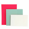Three sheets of sticky notes in shades of pink, teal, and white stacked together.