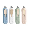 Four compact mini paper cutters in light blue, white, mint green, and pink with silver blades.