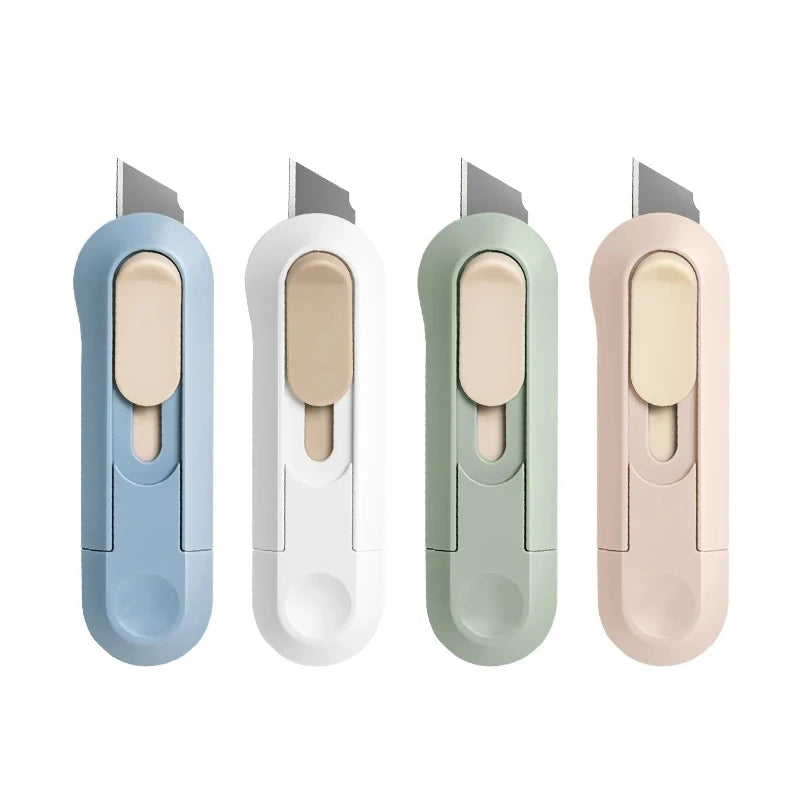 Four compact mini paper cutters in light blue, white, mint green, and pink with silver blades.