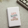 A white magnetic detachable folio cover for an e-reader featuring the text CATS BOOKS AND COFFEE in pink and green lettering.