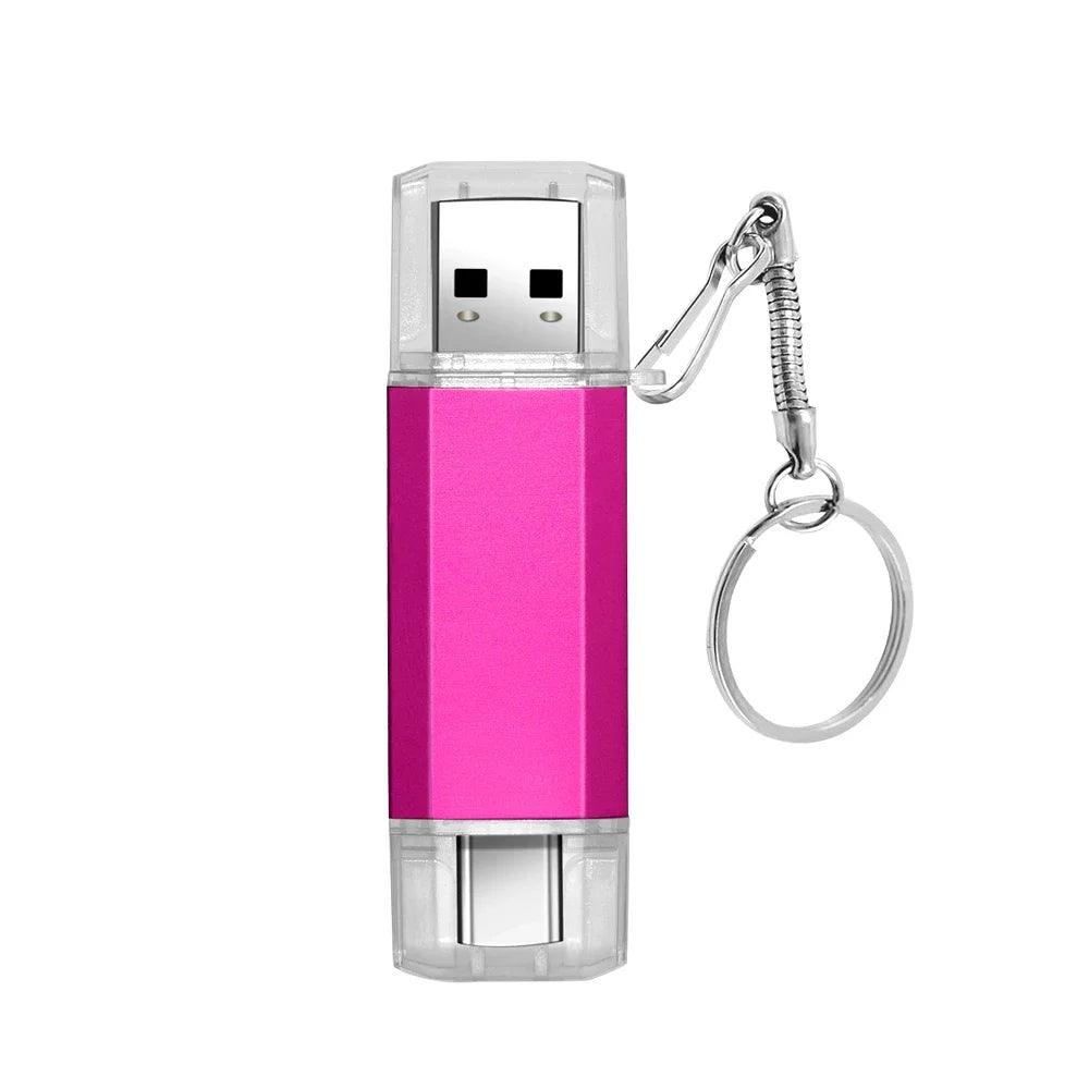 A pink dual USB and Type-C flash drive with a clear casing and a metal keyring attachment.