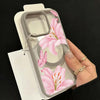 A hand holds a pink lily floral transparent iPhone case with a shockproof bumper.