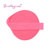 Pink bristleglass elastic hair ties and trims rolled into a flat band