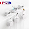 Twelve magnetic cable clips in white and black are shown for desk organization.