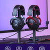 HyperX Cloud II headset headphones displayed on a desk with a computer monitor.