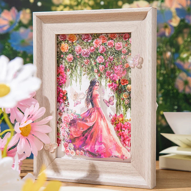 A framed watercolor illustration of a woman surrounded by pink and red floral vines and roses.