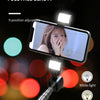 A dual LED fill light mounted on a selfie stick, illuminating a face for beauty photography.