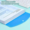 A stack of white paper inside a blue file folder with a push-button ring binder visible on a light green surface.