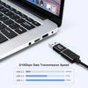 A close-up of a laptop keyboard and a USB-C adapter cable demonstrating various data transmission speeds.