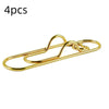 Four gold-colored multifunctional magnetic pen clips used for marking pages.