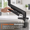 A hand is adjusting a black premium single monitor desk mount with a gas spring arm for tool-less organization.